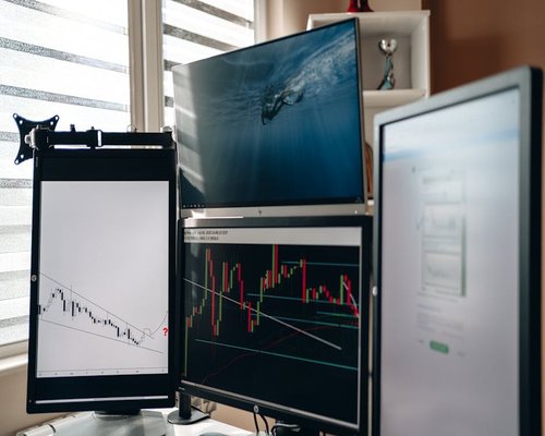 Close up view of a computer monitor displaying graphs in a home office